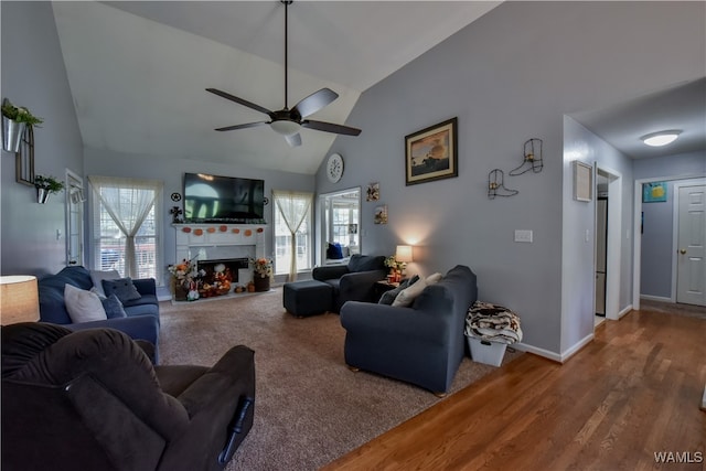 living room featuring hardwood / wood-style flooring, high vaulted ceiling, and ceiling fan