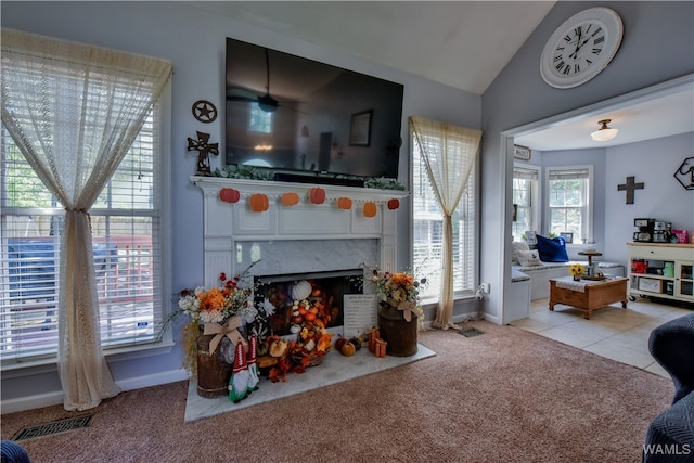 carpeted living room featuring lofted ceiling and a fireplace