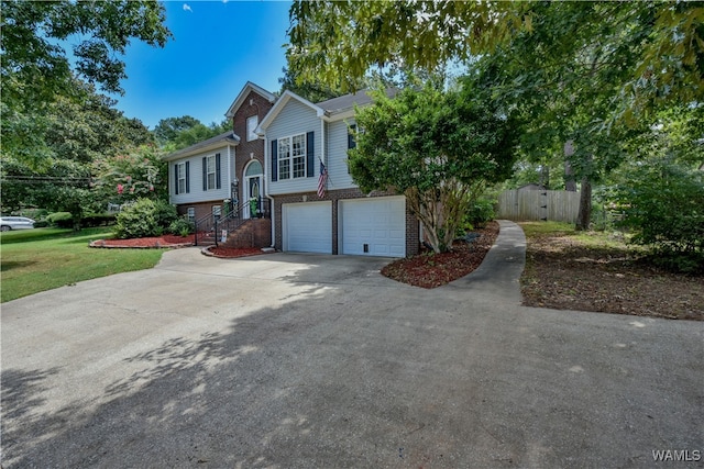 split foyer home with a garage and a front yard