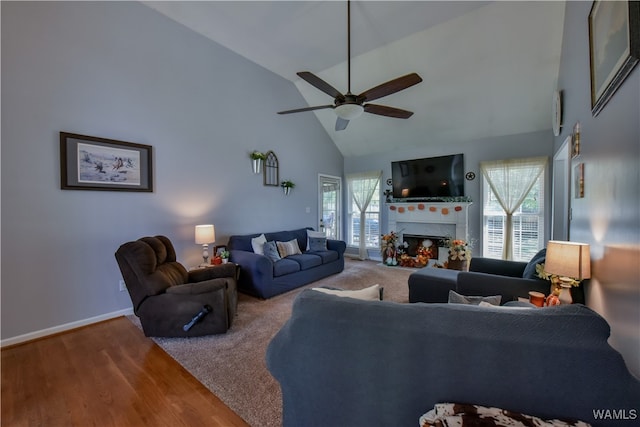 living room featuring hardwood / wood-style flooring, high vaulted ceiling, and ceiling fan