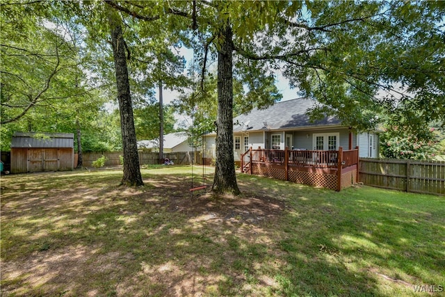 view of yard featuring a storage unit and a deck