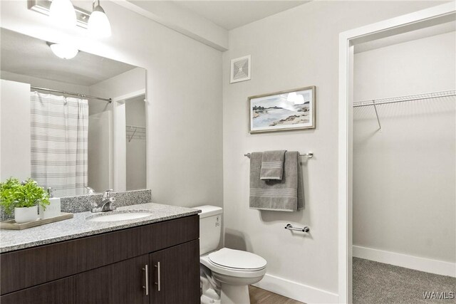 680 6th Ave NE Unit 3205, Tuscaloosa, AL 35404 - full bath with a spacious closet, toilet, vanity, and visible vents