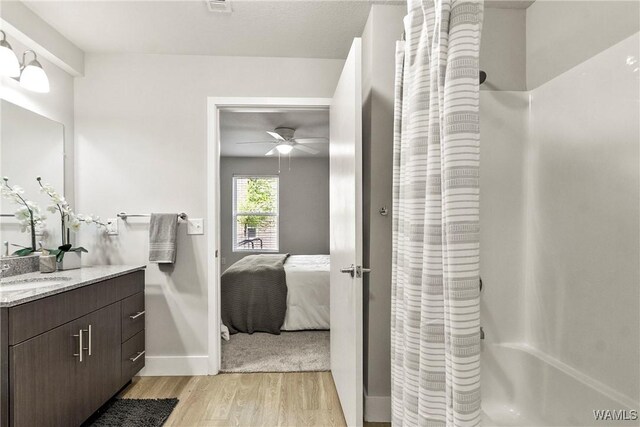 680 6th Ave NE Unit 3205, Tuscaloosa, AL 35404 - bathroom featuring vanity, a shower with shower curtain, connected bathroom, a ceiling fan, and wood finished floors