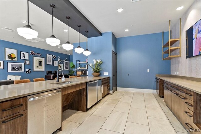 680 6th Ave NE Unit 3205, Tuscaloosa, AL 35404 - kitchen with light countertops, a sink, stainless steel dishwasher, visible vents, and decorative light fixtures