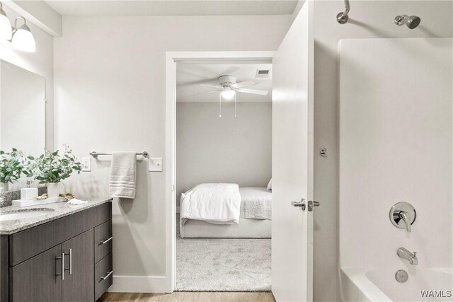 680 6th Ave NE Unit 3205, Tuscaloosa, AL 35404 - ensuite bathroom with connected bathroom, vanity,  shower combination, wood finished floors, and ceiling fan