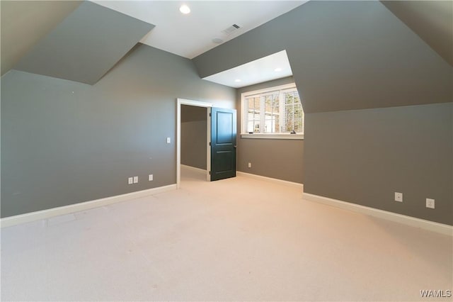 bonus room with vaulted ceiling and carpet