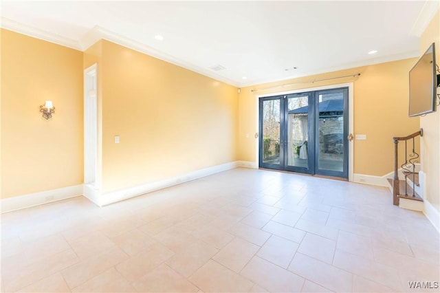 unfurnished room featuring crown molding and french doors