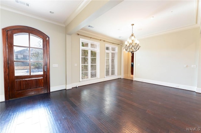 entrance foyer featuring ornamental molding, an inviting chandelier, and dark hardwood / wood-style flooring