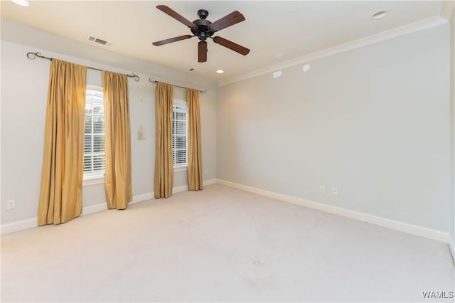 unfurnished room featuring ceiling fan, light colored carpet, and crown molding