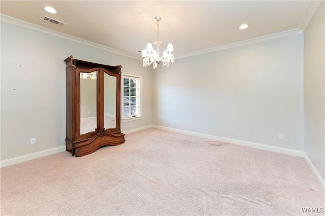 carpeted empty room featuring a chandelier and crown molding