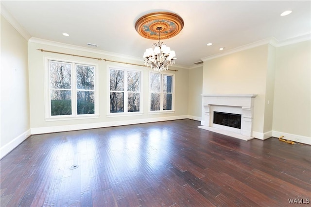 unfurnished living room featuring crown molding, dark hardwood / wood-style floors, and a notable chandelier