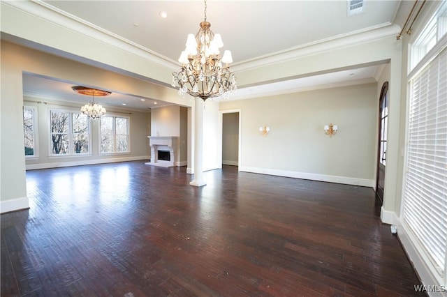 unfurnished living room with crown molding, dark hardwood / wood-style floors, and a notable chandelier