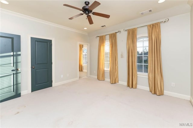 unfurnished room featuring light colored carpet, ceiling fan, and ornamental molding