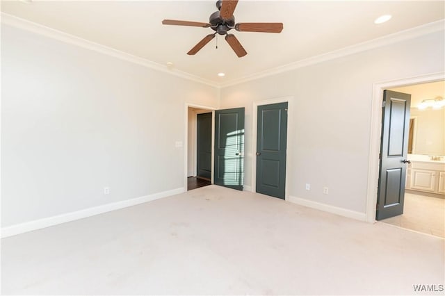 spare room featuring ceiling fan, light colored carpet, and ornamental molding