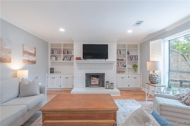 1603 Quail Run Dr, Tuscaloosa, AL 35406 - living area featuring a brick fireplace, light wood-type flooring, built in shelves, and recessed lighting