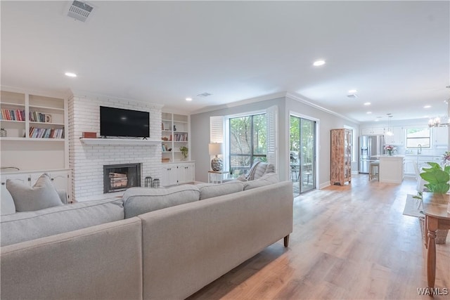 1603 Quail Run Dr, Tuscaloosa, AL 35406 - living room with a fireplace, light wood-type flooring, plenty of natural light, crown molding, and recessed lighting