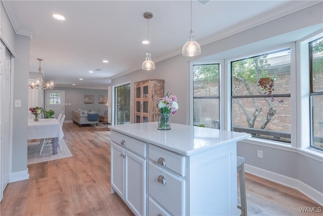 1603 Quail Run Dr, Tuscaloosa, AL 35406 - kitchen featuring baseboards, white cabinetry, a chandelier, crown molding, and light wood-type flooring