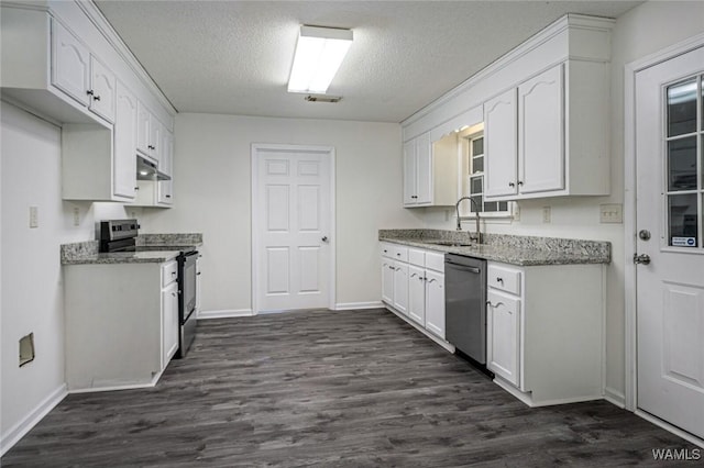 kitchen featuring dark hardwood / wood-style floors, white cabinetry, sink, stainless steel appliances, and a textured ceiling