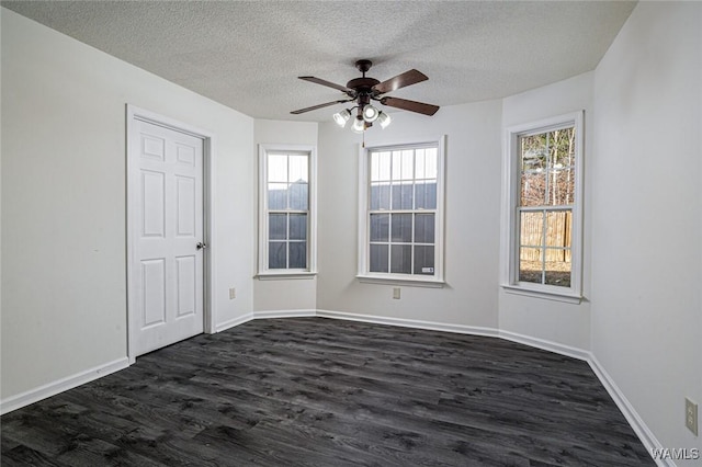 unfurnished room with ceiling fan, dark hardwood / wood-style flooring, and a textured ceiling