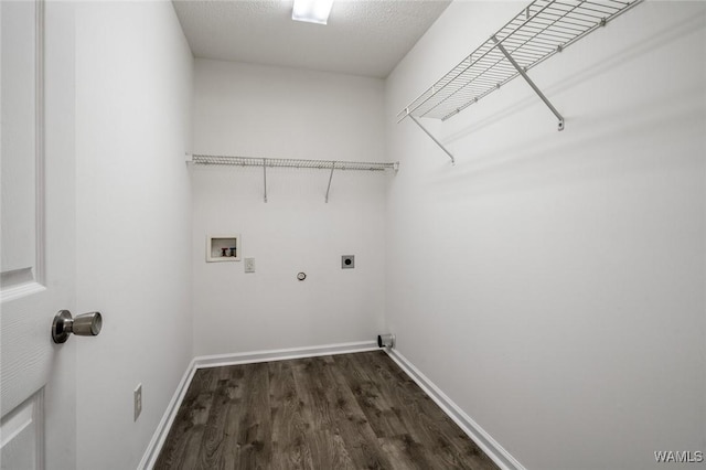 clothes washing area with gas dryer hookup, dark wood-type flooring, electric dryer hookup, washer hookup, and a textured ceiling