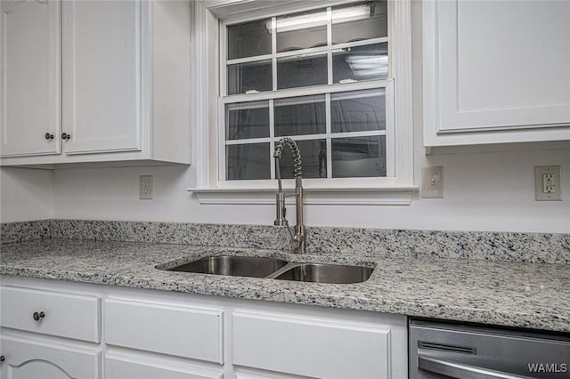 kitchen featuring white cabinetry, dishwasher, sink, and light stone counters