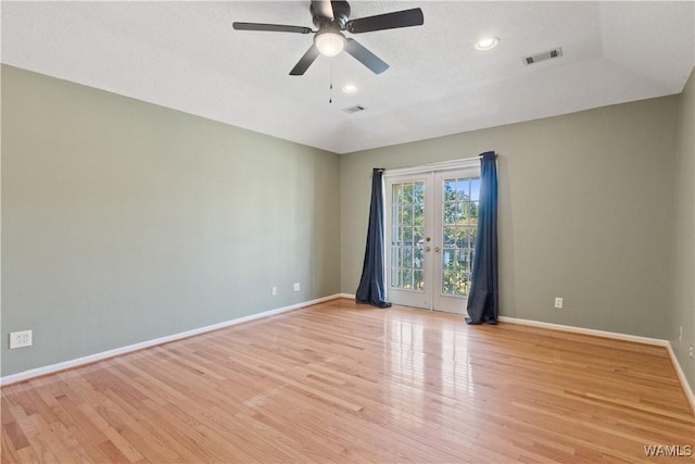 unfurnished room featuring visible vents, light wood-style flooring, french doors, and baseboards