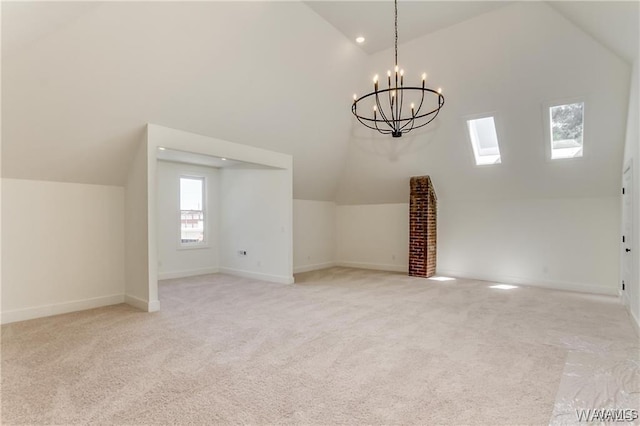 interior space featuring light carpet, vaulted ceiling, and a notable chandelier