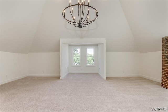 additional living space featuring a chandelier, light colored carpet, and vaulted ceiling