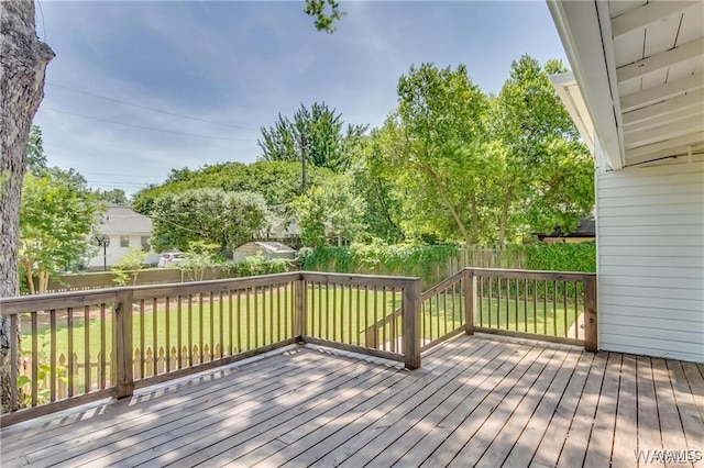 wooden terrace featuring a lawn