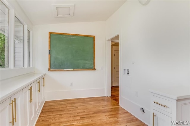 hallway featuring light hardwood / wood-style flooring and vaulted ceiling