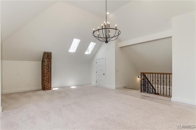 additional living space featuring light carpet, an inviting chandelier, and lofted ceiling with skylight