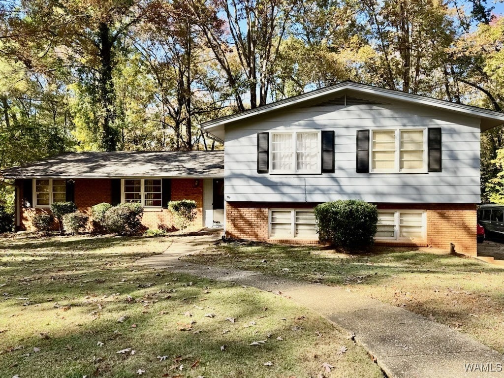 tri-level home with a front yard