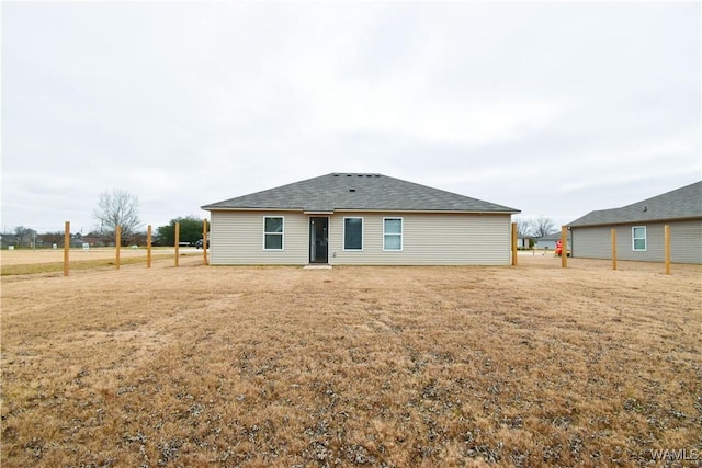 rear view of house with a yard