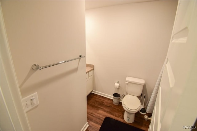 bathroom featuring vanity, wood-type flooring, and toilet