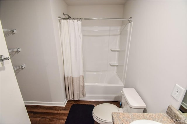 full bathroom featuring hardwood / wood-style floors, vanity, toilet, and shower / bath combo