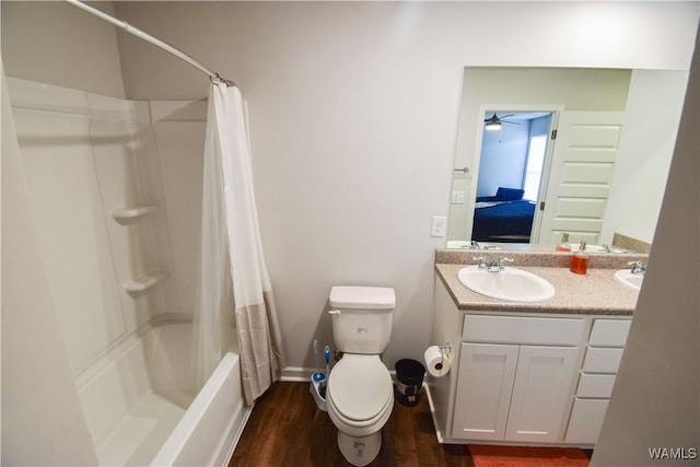 full bathroom with vanity, hardwood / wood-style flooring, ceiling fan, toilet, and shower / bathtub combination with curtain