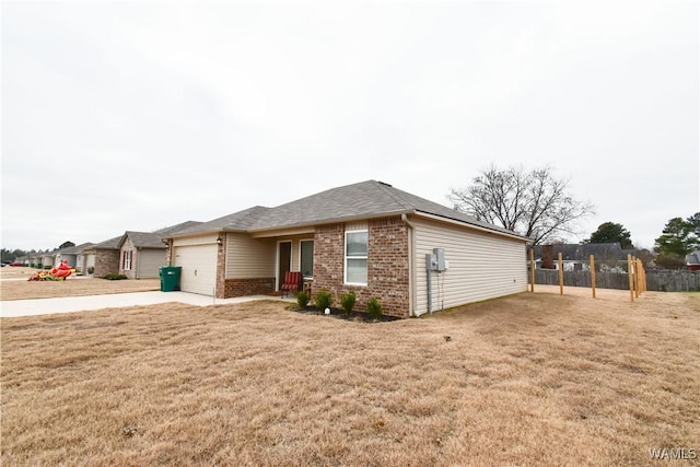 ranch-style home with a front yard and a garage