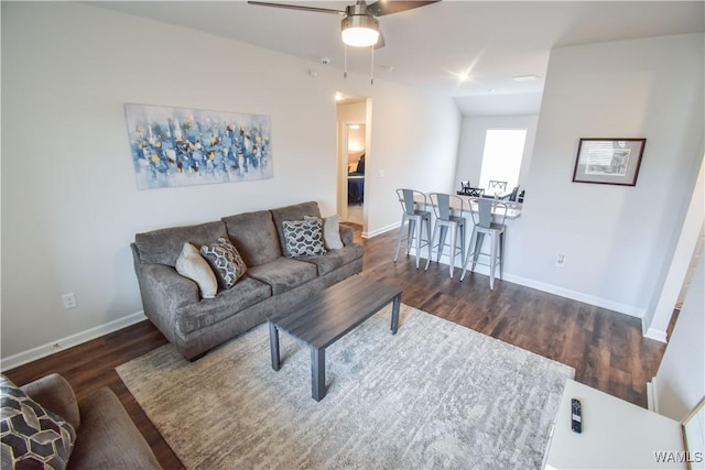 living room with ceiling fan and dark hardwood / wood-style flooring