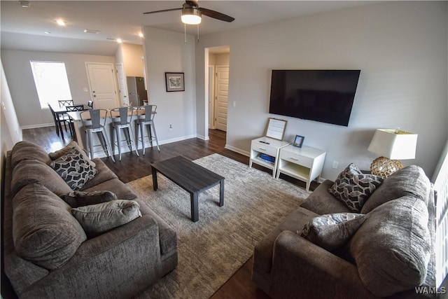 living room featuring dark hardwood / wood-style flooring and ceiling fan