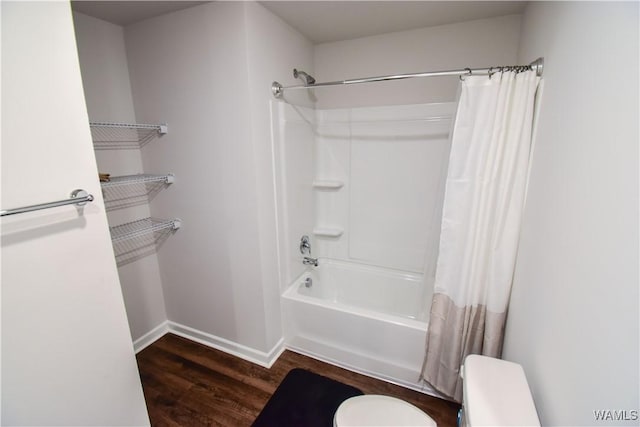 bathroom featuring wood-type flooring, toilet, and shower / bath combination with curtain