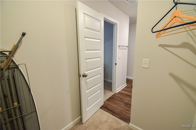 walk in closet with hardwood / wood-style flooring