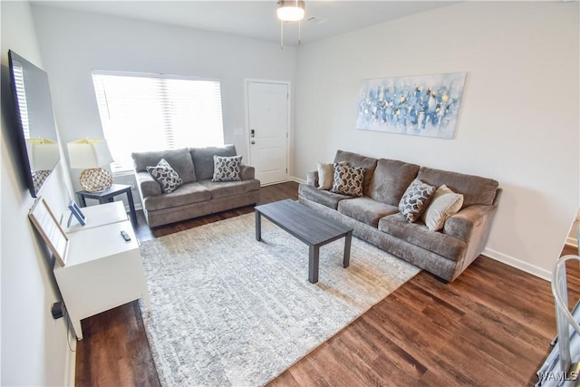 living room with ceiling fan and dark hardwood / wood-style floors