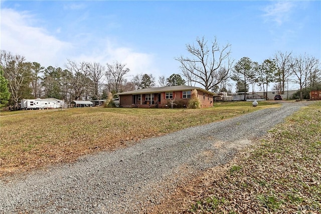 single story home featuring driveway and a front yard