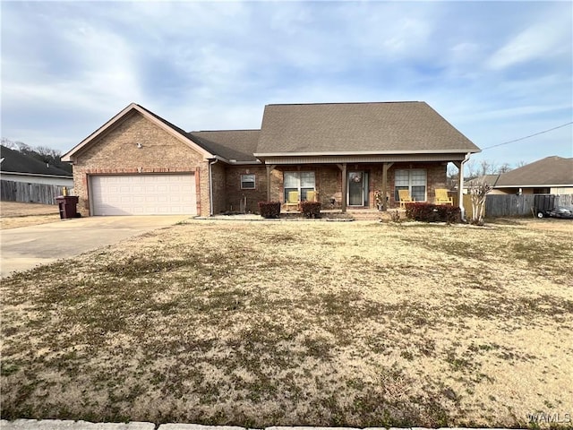 view of front of home featuring a porch, a garage, and a front yard