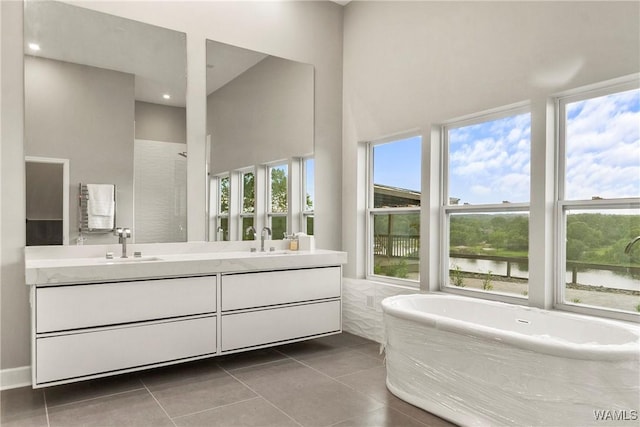 bathroom featuring tile patterned floors, a water view, and a wealth of natural light