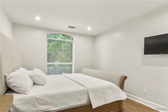 bedroom with wood-type flooring