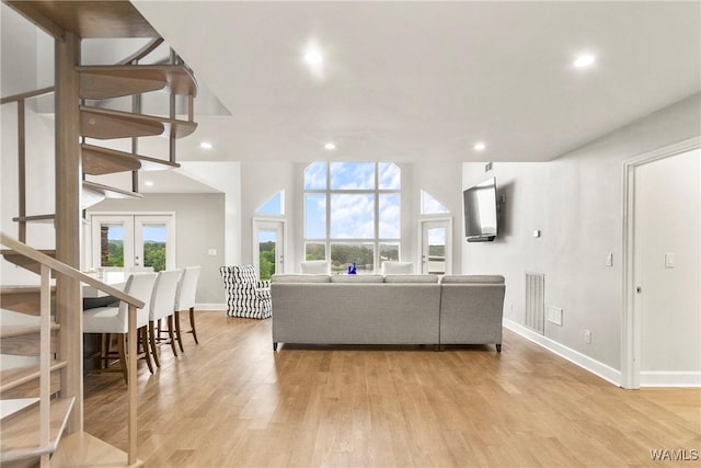 living room featuring light hardwood / wood-style flooring and french doors