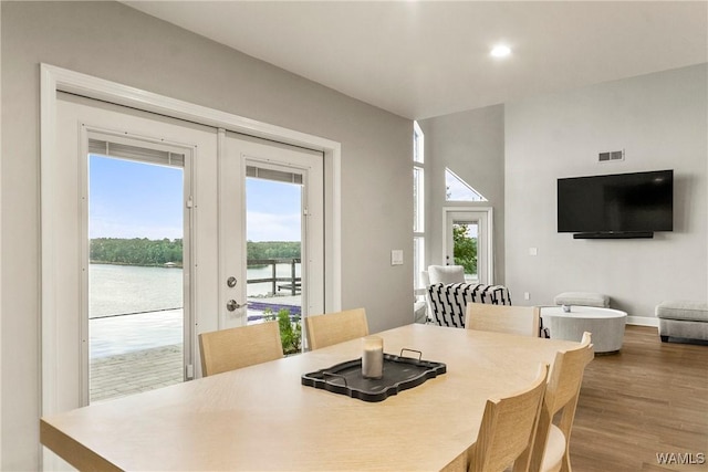 dining area featuring hardwood / wood-style flooring, plenty of natural light, and french doors