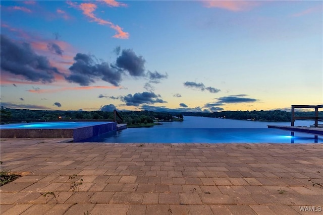 pool at dusk with a water view