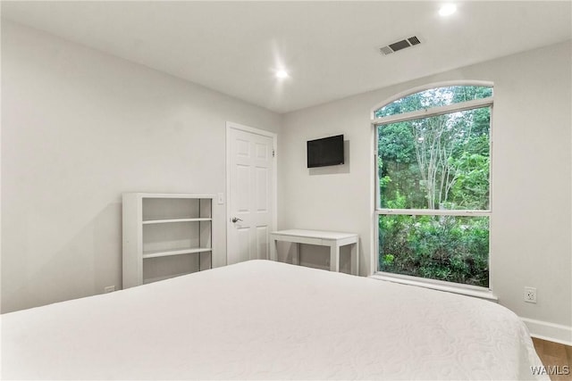 bedroom with hardwood / wood-style floors